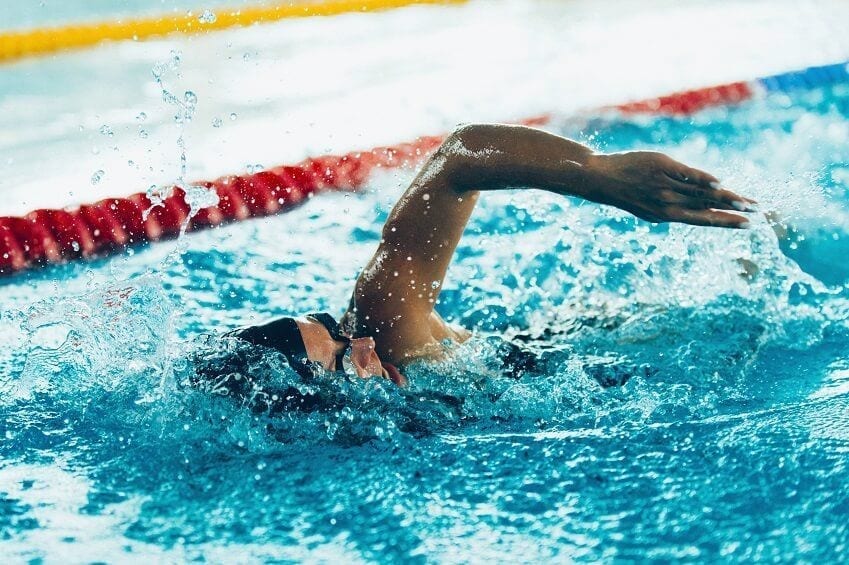 A swimmer, swimming in a pool.