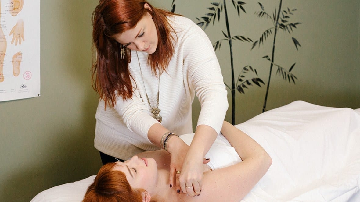 Rachel Smith (with model Katy Albright on her table) treats her patients with a needle here, a homemade salve there, and a sprinkling of Eastern philosophy.