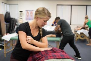 female massage therapy school student