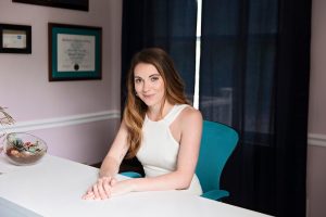 A photo of Kacy Korczyk sitting at a desk.