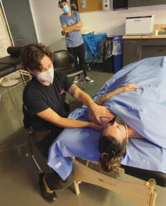 A massage therapist works on a patient.
