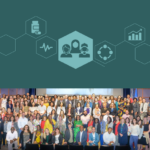 Large group of people on a stage in front of a screen at NIH