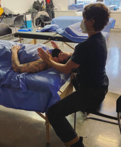 A massage therapist works on a patient.